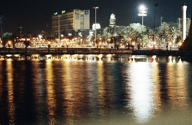 t001-031 Reflections in the lake in front of Tripoli castle. Grand Hotel and Mosque of Shara Maghrief in long view...A long shot at life..Tripoli's evening charms